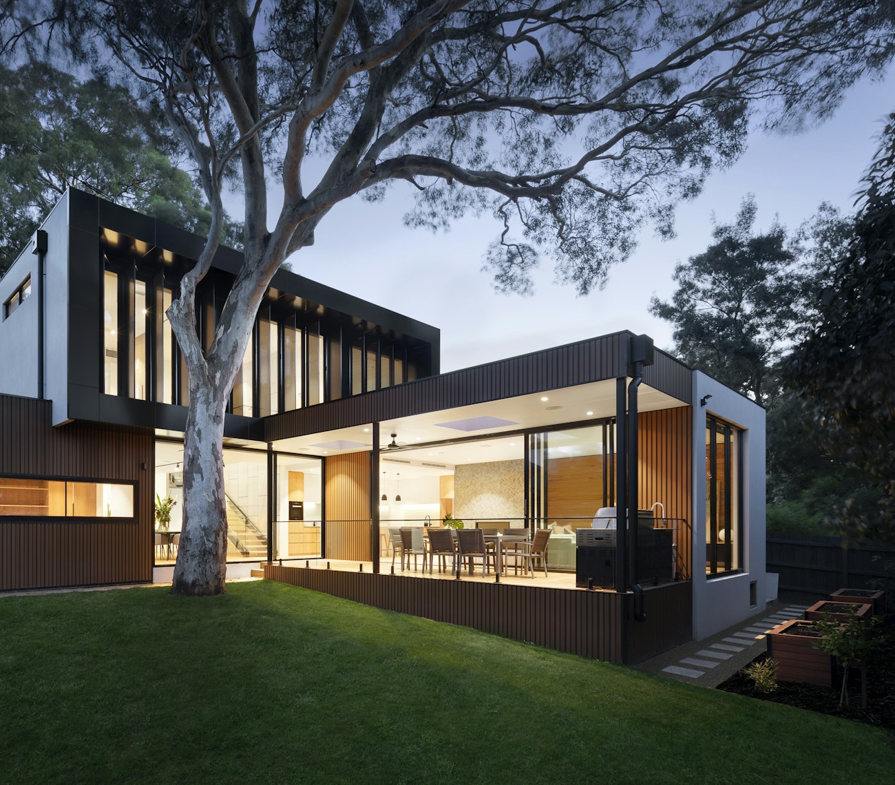 A contemporary Melbourne home lit up at dusk